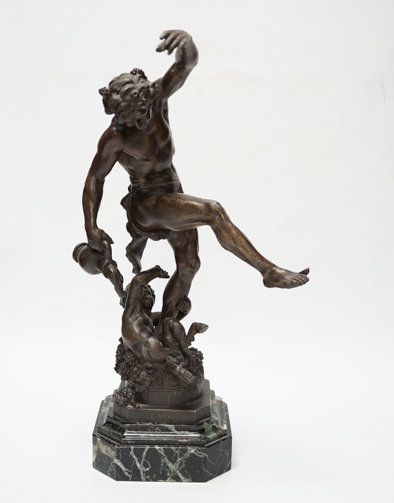 A bronzed spelter dancing figure of Bacchus - ‘Le Vin’, with a fawn and bunches of grapes, on a marble base, 36cm high